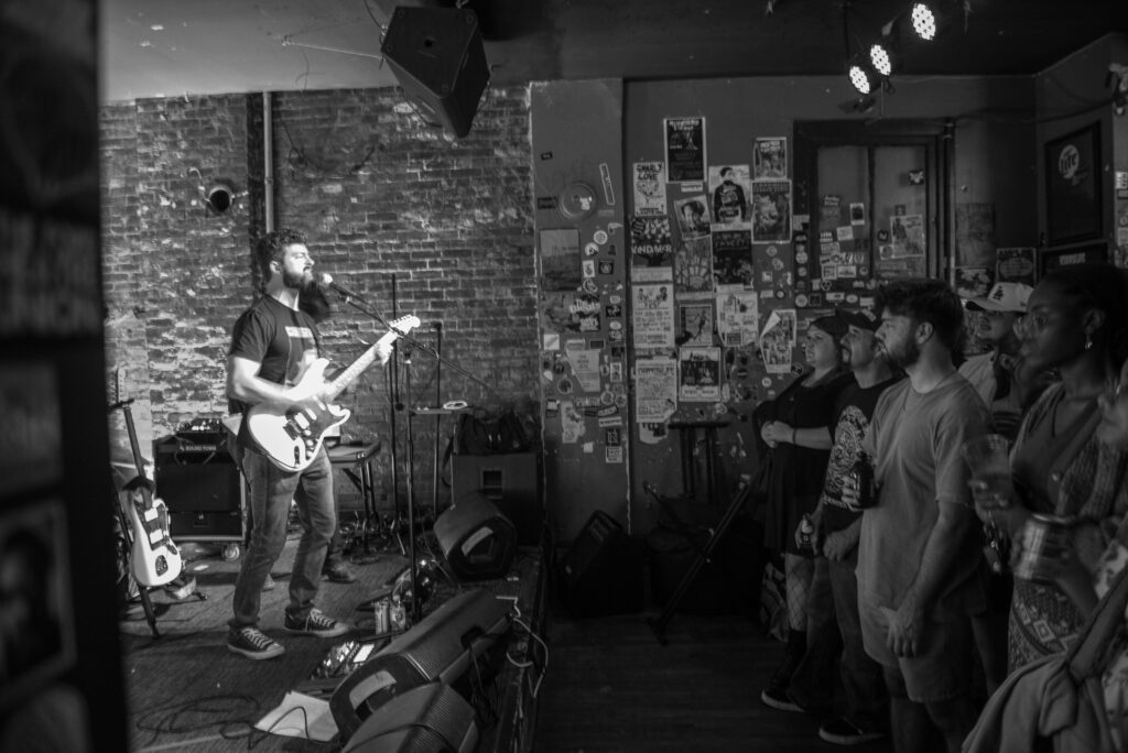 Cigarette Trees performing to crowd in black and white
